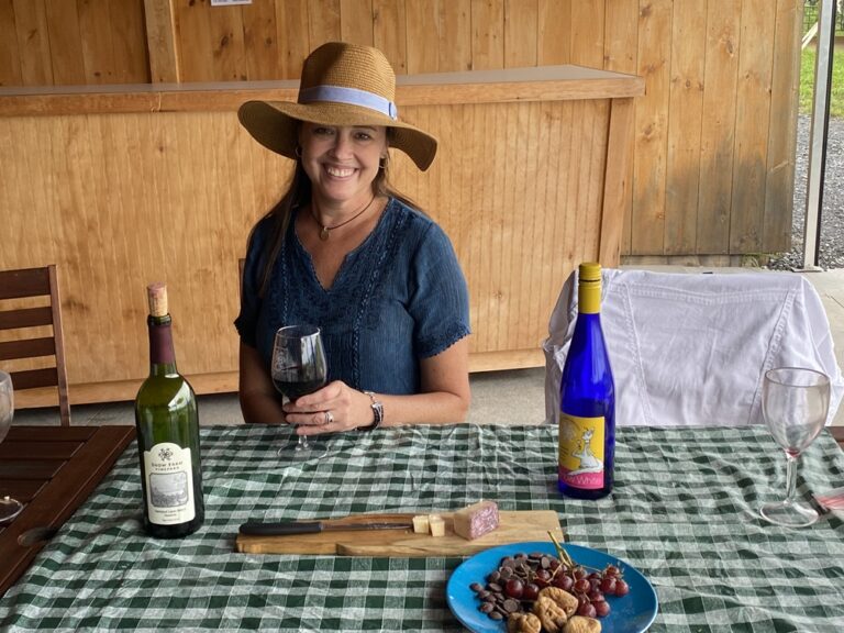 Vermont wine types and styles woman tasting wine at picnic table