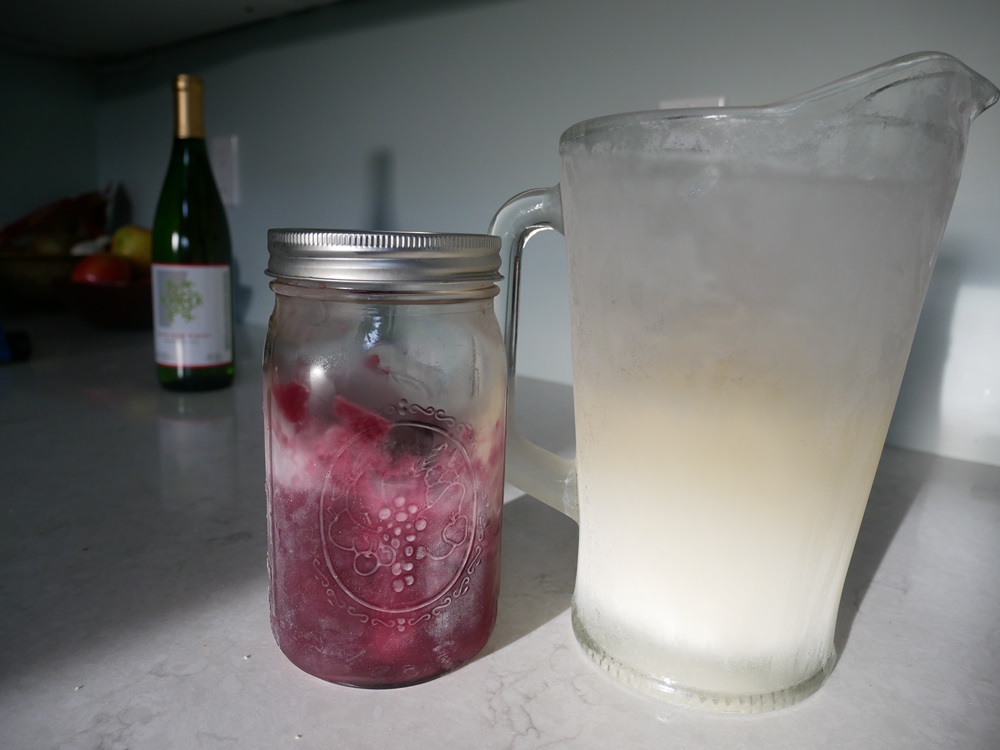 red and white wine slushies in a pitcher and mason jar
