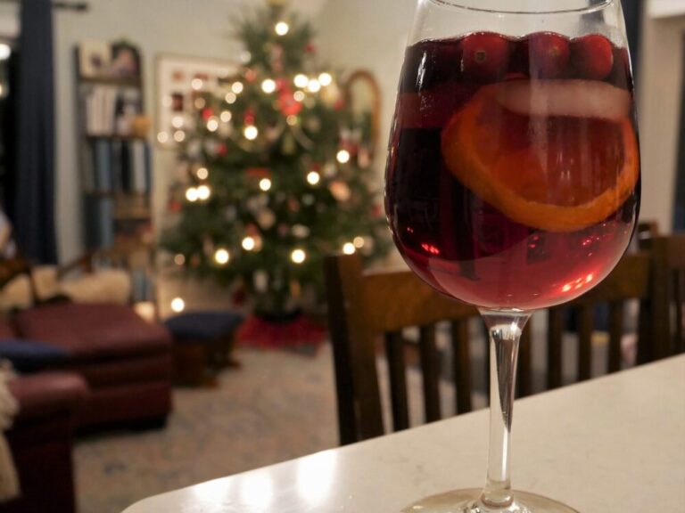 winter sangria on a bar with a christmas tree in the background