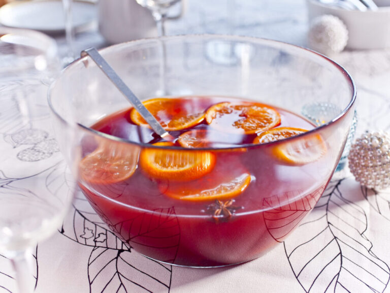 holiday wine punch with oranges on a table