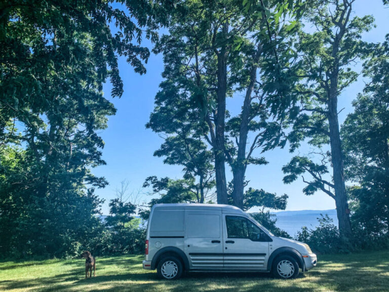 camper van at a lakeside hip camp site